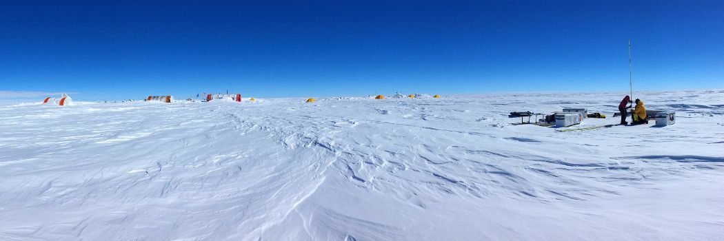 A snow and icy landscape with a clear blue sky